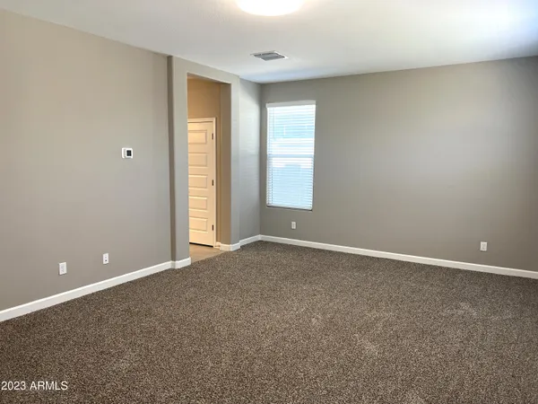 an empty room with windows and closet