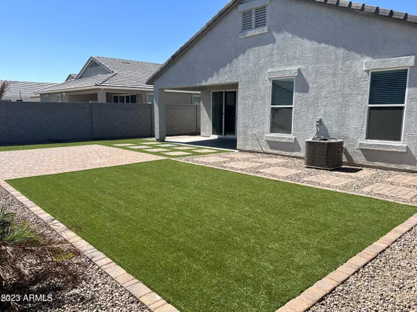 a view of a house with a yard and sitting area