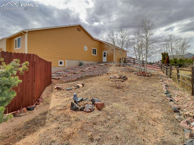 This lovely home is situated on 1/2 acre lot.  There are concrete steps leading from the front of the house to the back yard.