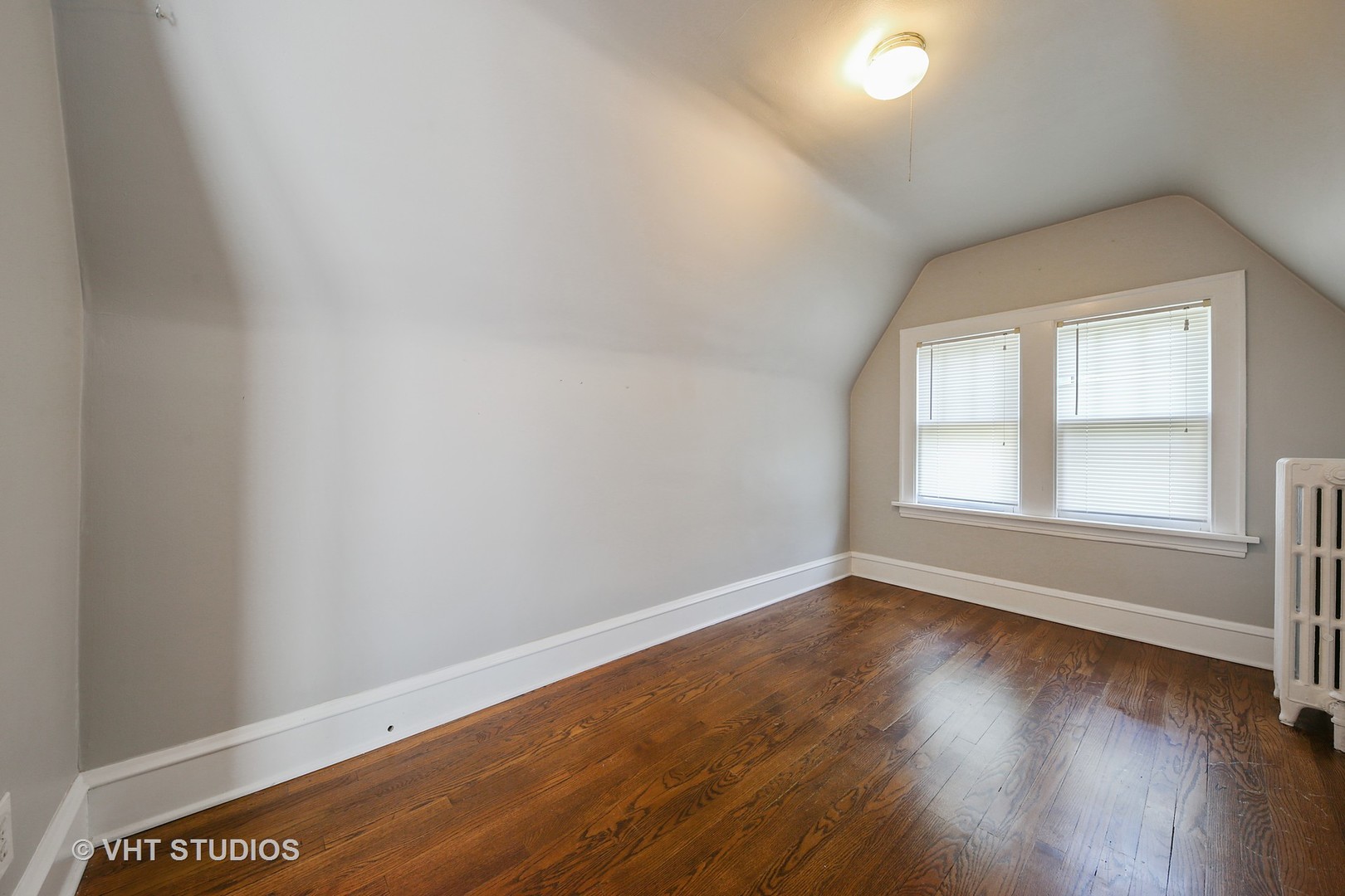 612 Spring Road Elmhurst, IL 60126 - Photo 11 of 19 an empty room with wooden floor and windows