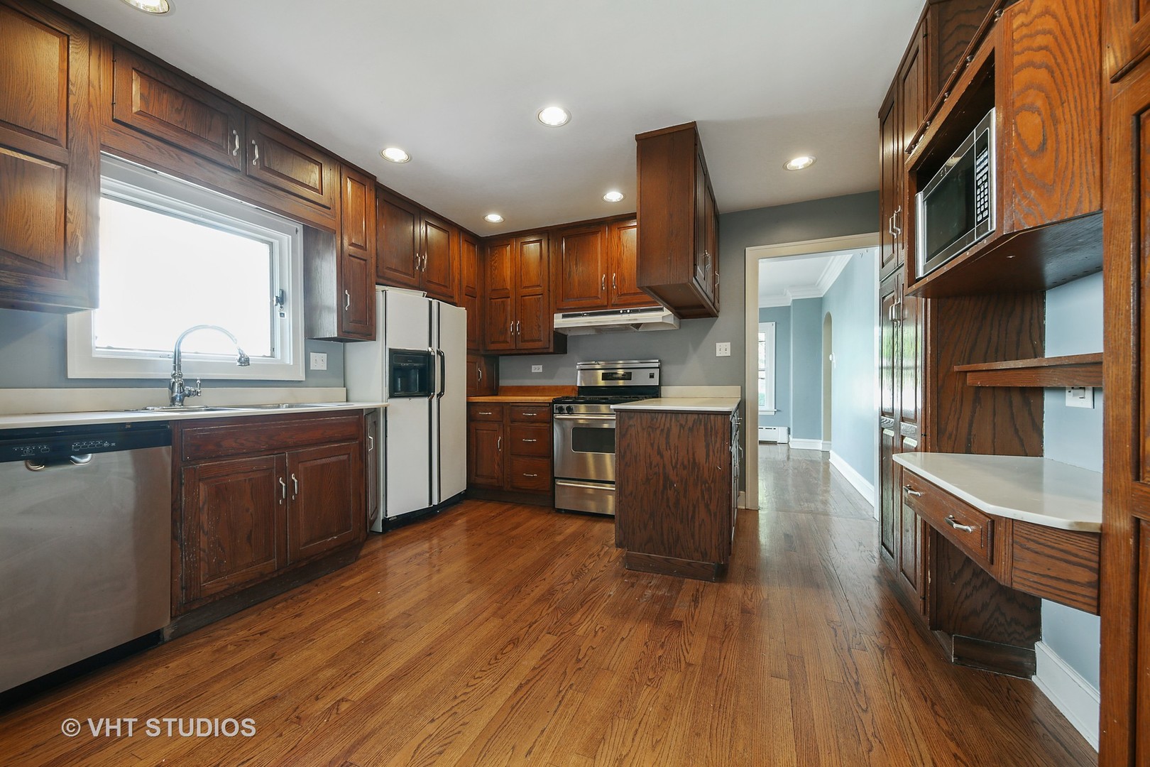 612 Spring Road Elmhurst, IL 60126 - Photo 2 of 19 a kitchen with stainless steel appliances granite countertop a sink a stove and a refrigerator