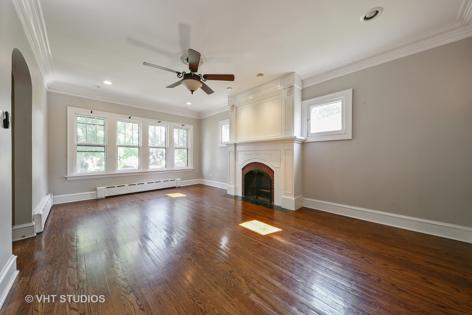 612 Spring Road Elmhurst, IL 60126 - Photo 6 of 19 a view of empty room with wooden floor and fireplace