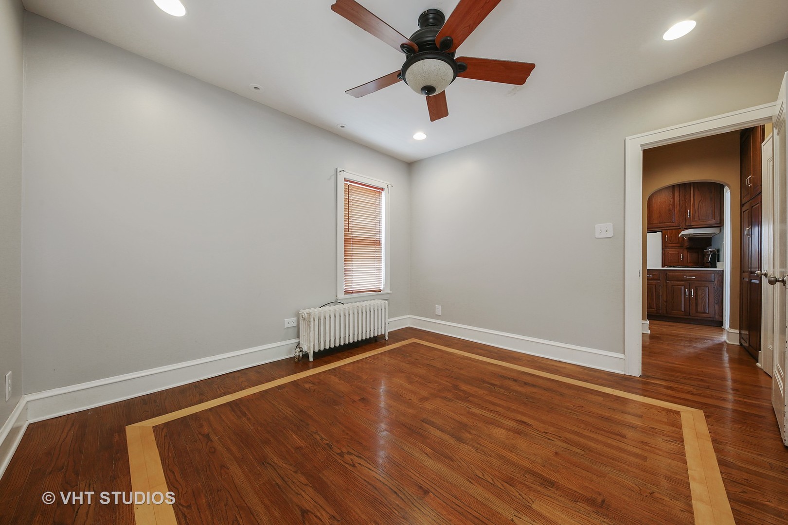 612 Spring Road Elmhurst, IL 60126 - Photo 9 of 19 an empty room with wooden floor chandelier fan and windows