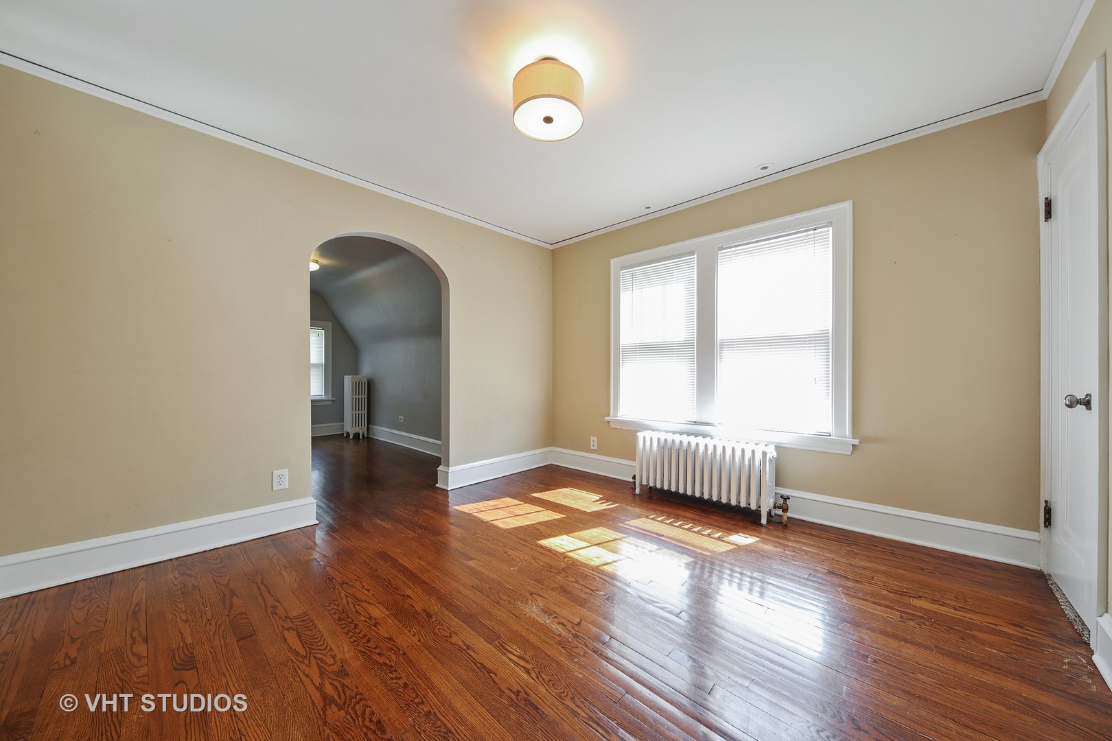 612 Spring Road Elmhurst, IL 60126 - Photo 10 of 19 an empty room with wooden floor and windows