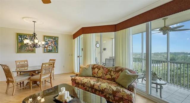 a very nice looking living room with a large window and furniture