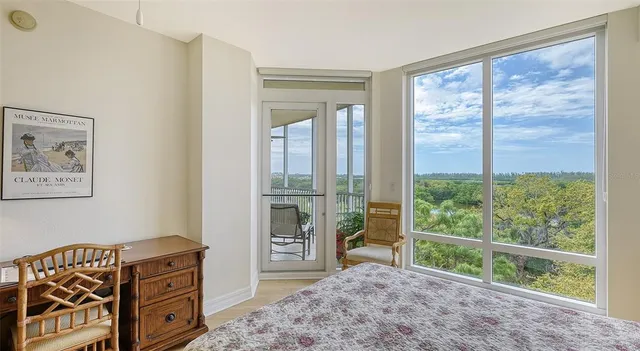 a front view of a building with palm trees and sign board