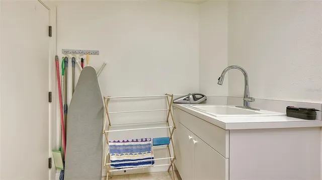 a living room with furniture and a floor to ceiling windows