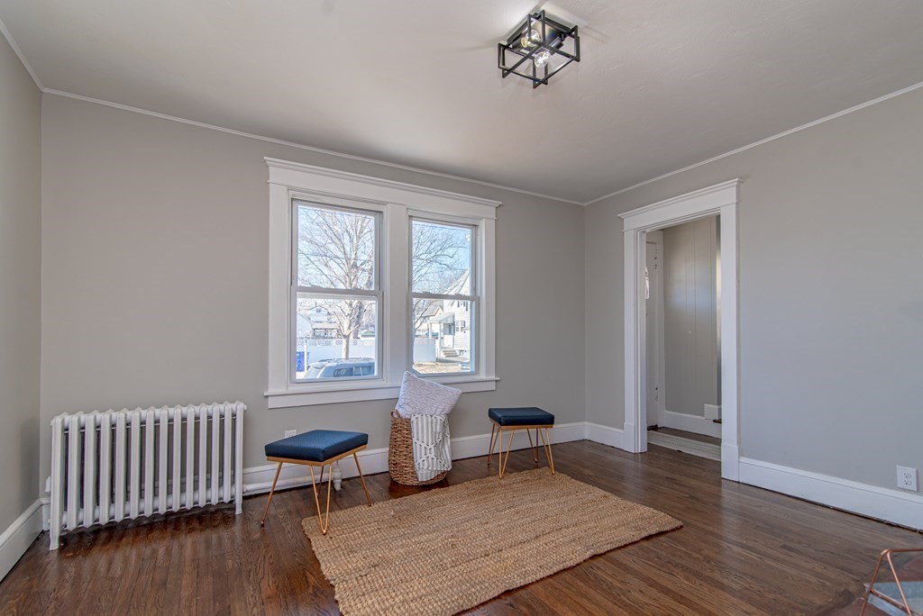 91 Wilber Street Springfield, MA 01104 - Photo 8 of 24 an empty room with wooden floor and windows
