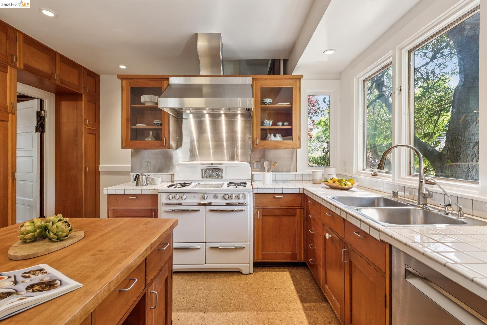 1490 Arch Street Berkeley, CA 94708 - Photo 18 of 57 a kitchen with stainless steel appliances granite countertop a sink stove and refrigerator