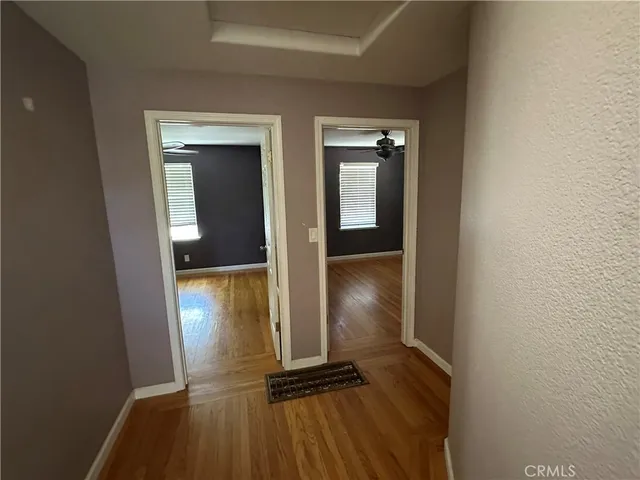 an empty room with windows and closet