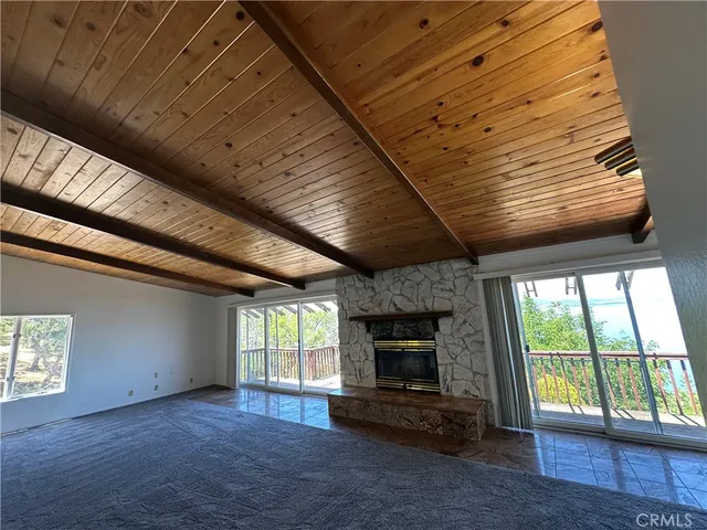 a living room with stainless steel appliances kitchen island granite countertop furniture and a fireplace