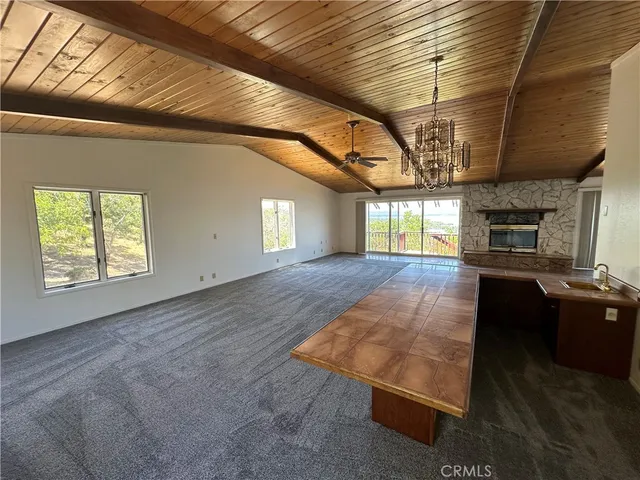 an empty room with a fireplace and window