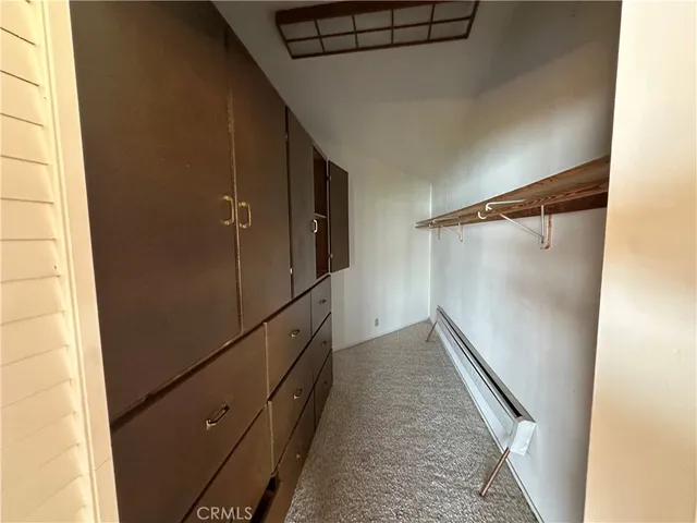 a view of empty room with a fireplace and window