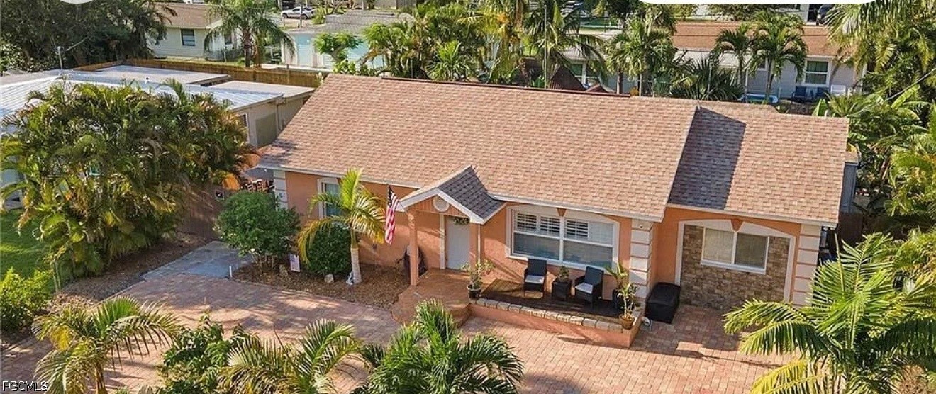 1535 Ransom Street Fort Myers, FL 33901 - Photo 2 of 4 a view of a house with a yard and potted plants