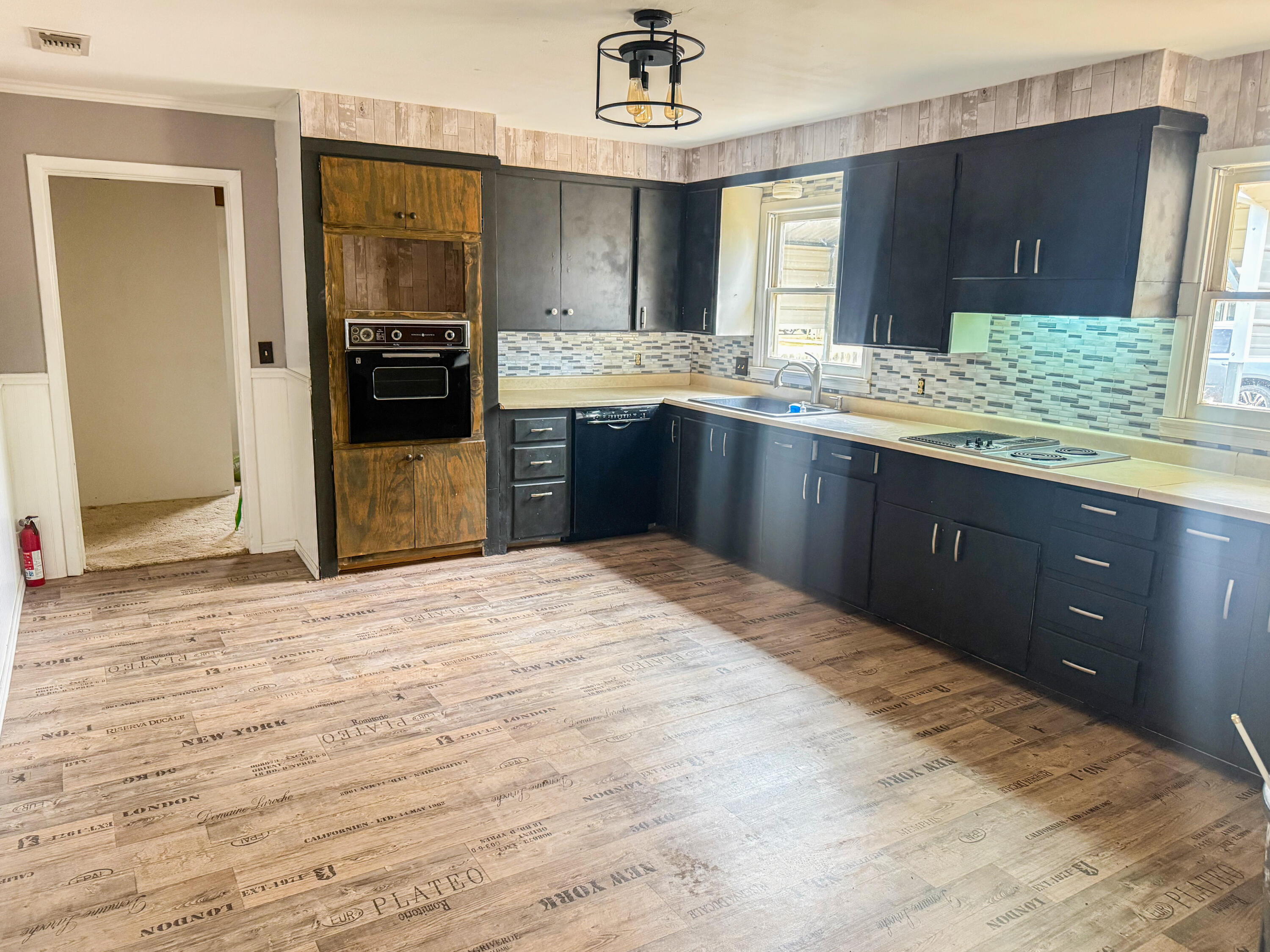 601 Northeast 3rd Street Earth, TX 79031 - Photo 6 of 8 a kitchen with granite countertop a refrigerator and a sink
