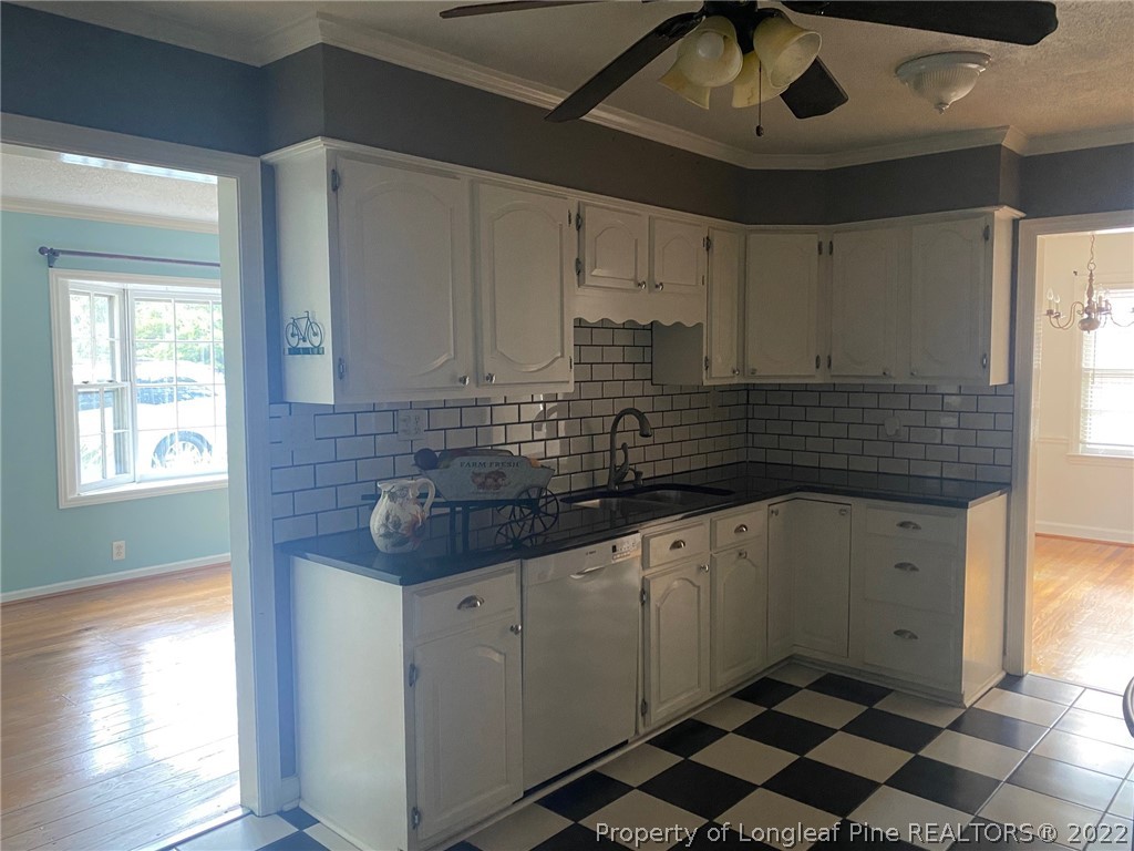 1811 Lyon Road Fayetteville, NC 28303 - Photo 14 of 27 a kitchen that has a sink and a stove