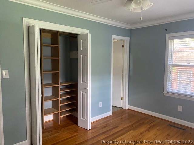 1811 Lyon Road Fayetteville, NC 28303 - Photo 19 of 27 a view of an empty room with wooden floor and a window