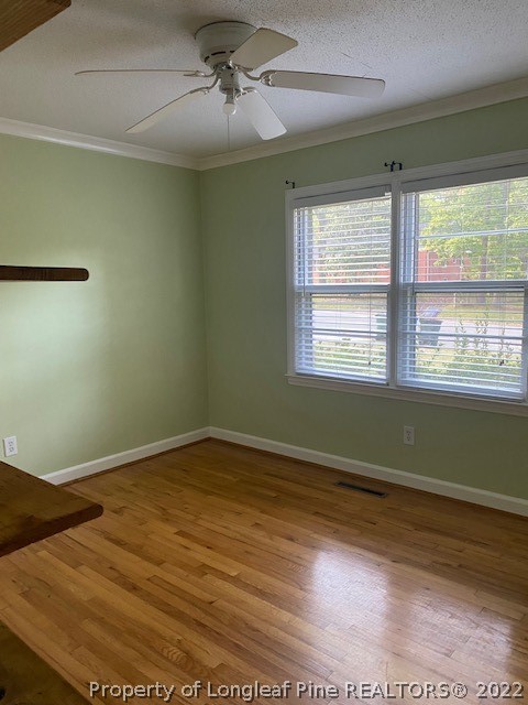 1811 Lyon Road Fayetteville, NC 28303 - Photo 22 of 27 a view of an empty room with wooden floor and a window