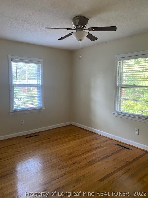 1811 Lyon Road Fayetteville, NC 28303 - Photo 24 of 27 a view of an empty room with wooden floor and a window