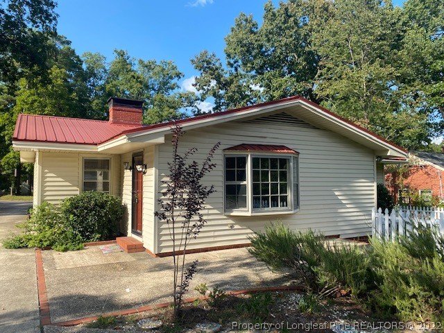 1811 Lyon Road Fayetteville, NC 28303 - Photo 7 of 27 a front view of a house with garden