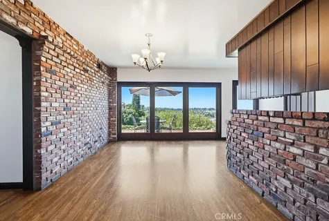 a kitchen with stainless steel appliances granite countertop a refrigerator oven a sink dishwasher and a stove with wooden floor