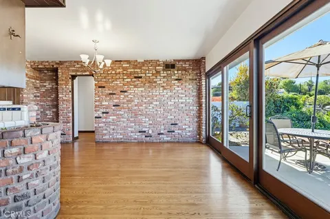 a kitchen with stainless steel appliances granite countertop a refrigerator a stove and a wooden floors