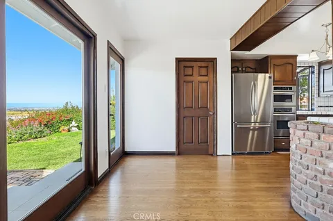 a kitchen with stainless steel appliances granite countertop a stove a sink dishwasher and a refrigerator