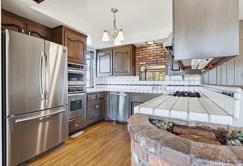 2141 Ronsard Road Rancho Palos Verdes, CA 90275 - Photo 18 of 69 a kitchen with stainless steel appliances granite countertop a refrigerator a stove and a wooden floors