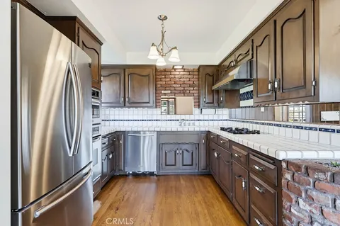 a kitchen with stainless steel appliances granite countertop a sink and cabinets