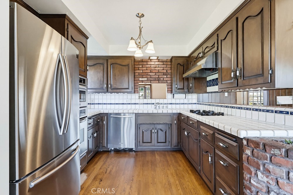 2141 Ronsard Road Rancho Palos Verdes, CA 90275 - Photo 19 of 69 a kitchen with stainless steel appliances granite countertop a stove a sink dishwasher and a refrigerator