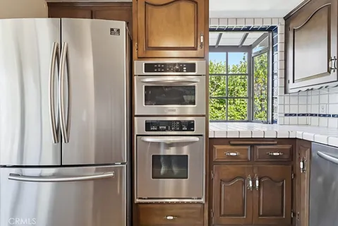 a kitchen with stainless steel appliances granite countertop a sink and cabinets
