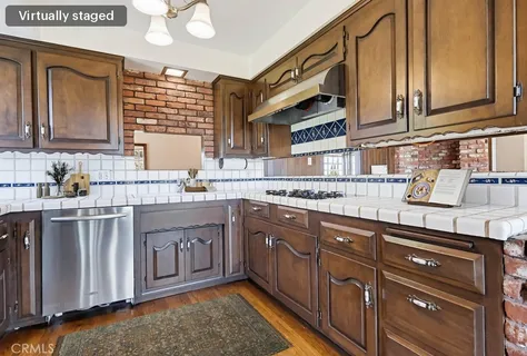a kitchen with stainless steel appliances granite countertop a stove a sink and a cabinets