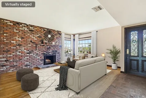 wooden floor fireplace and windows in an empty room