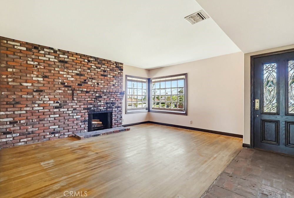 2141 Ronsard Road Rancho Palos Verdes, CA 90275 - Photo 5 of 69 wooden floor fireplace and windows in an empty room