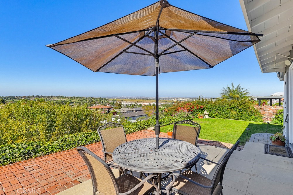 2141 Ronsard Road Rancho Palos Verdes, CA 90275 - Photo 52 of 69 a view of a patio with a table chairs and a umbrella