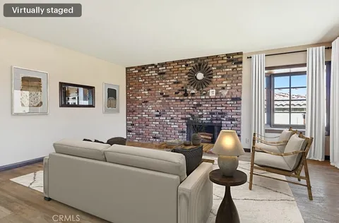 wooden floor fireplace and windows in an empty room