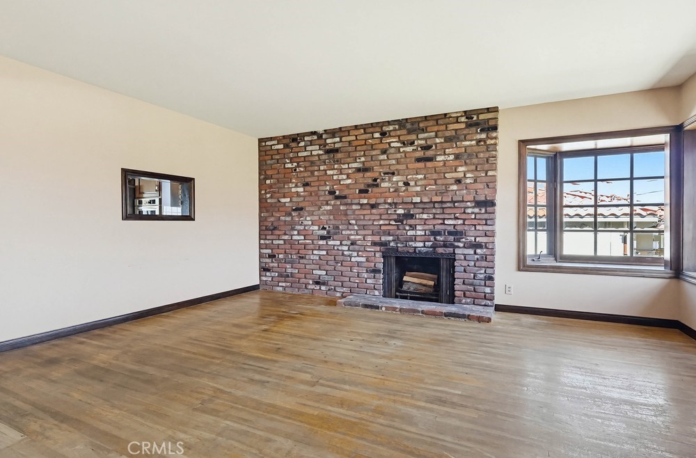 2141 Ronsard Road Rancho Palos Verdes, CA 90275 - Photo 7 of 69 wooden floor fireplace and windows in an empty room