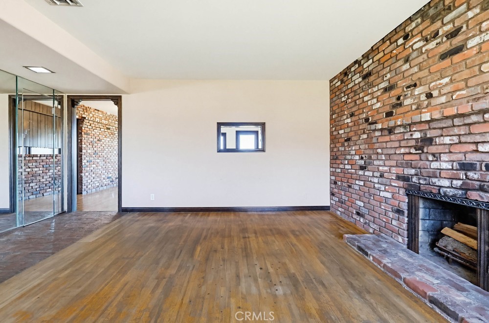 2141 Ronsard Road Rancho Palos Verdes, CA 90275 - Photo 10 of 69 an empty room with wooden floor and a fireplace