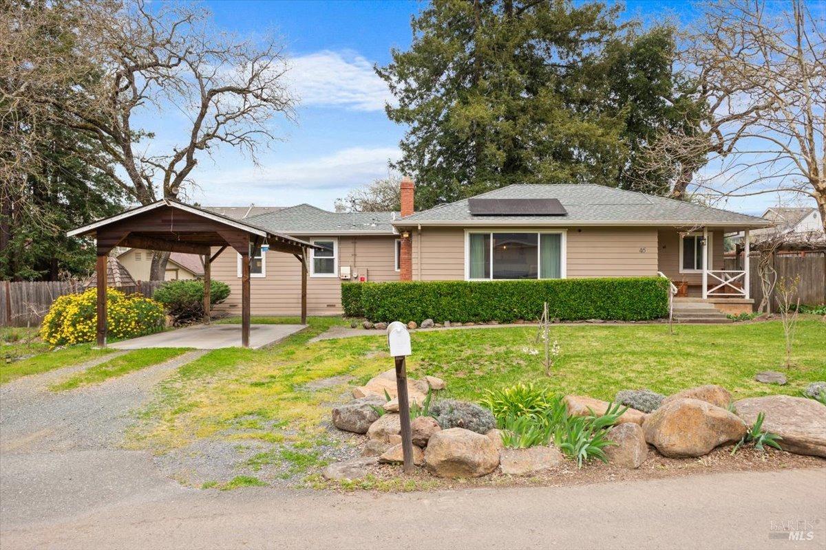 46 Randall Lane Santa Rosa, CA 95409 - Photo 1 of 1 a front view of a house with a yard table and chairs