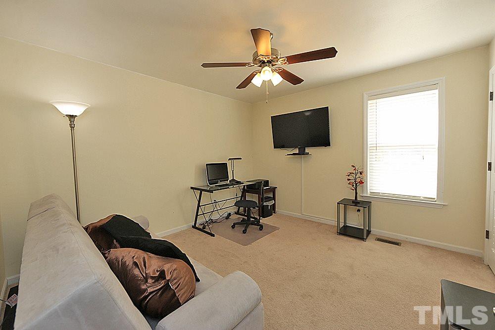 263 Rosa Circle Willow Spring, NC 27592 - Photo 14 of 24 a living room with furniture and a flat screen tv