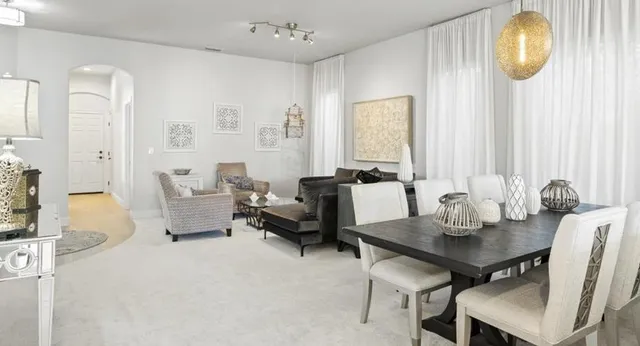 a view of a dining room with furniture and chandelier