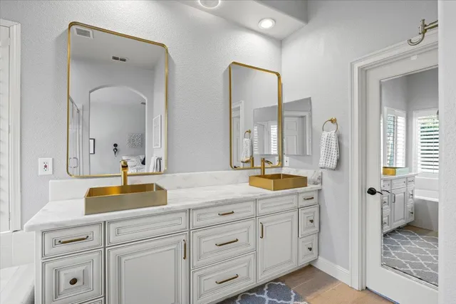 a bathroom with double sink and a mirror