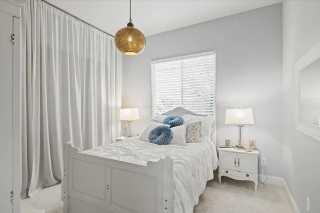 a bedroom with a bed and a chandelier