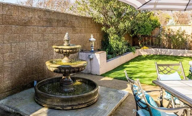 a view of a swimming pool with a patio and a yard