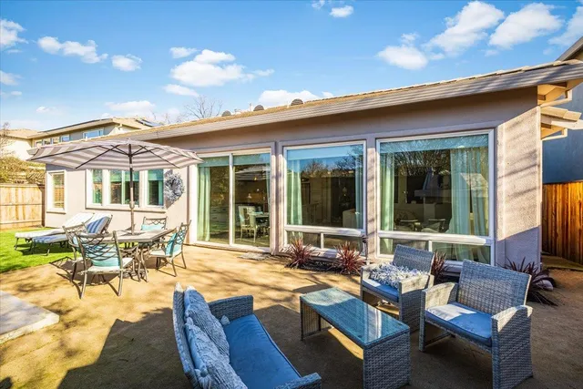 a view of a house with swimming pool and sitting area