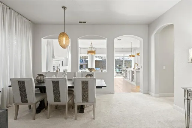 a view of a dining room with furniture and chandelier