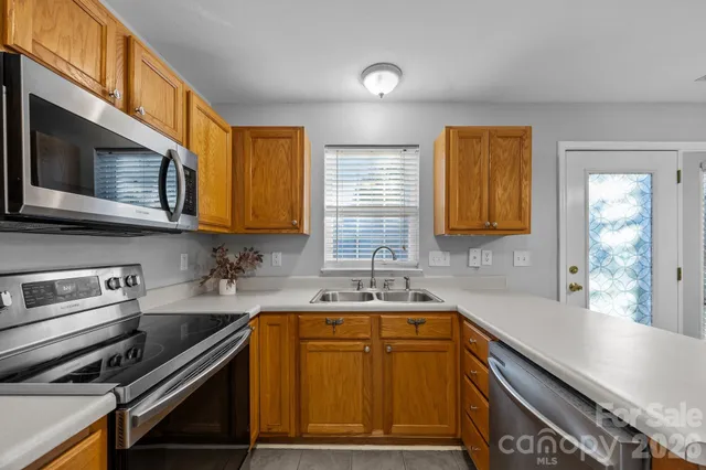a kitchen that has a sink and a stove