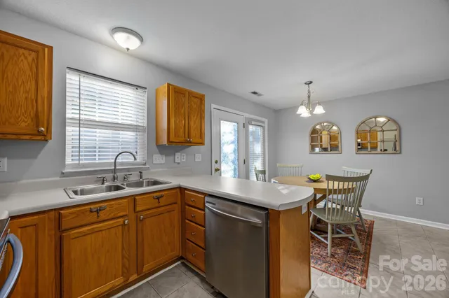 a kitchen with a sink cabinets and window