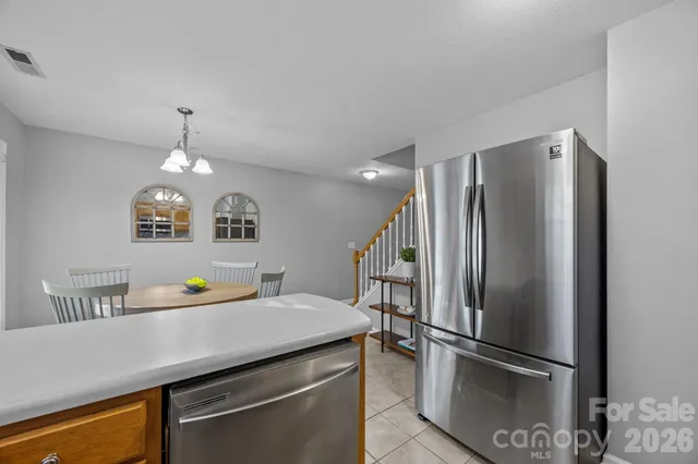 a kitchen with stainless steel appliances a refrigerator and a sink