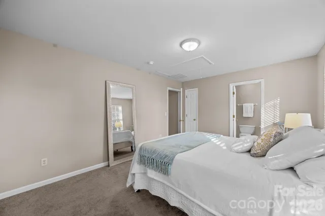 a bedroom with a bed and a lamp